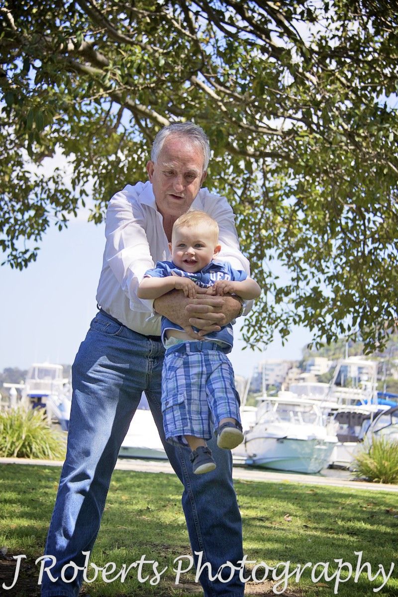 Little boy being swung by his grandpa - family portrait photography sydney
